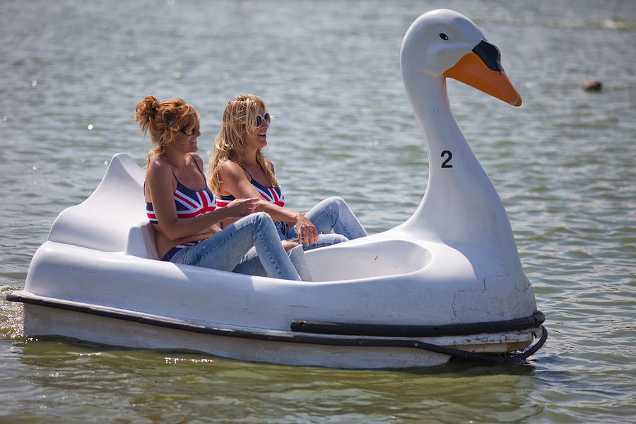 Sisters share swan shaped pedalo Photograph by Paul Mansfield Photography