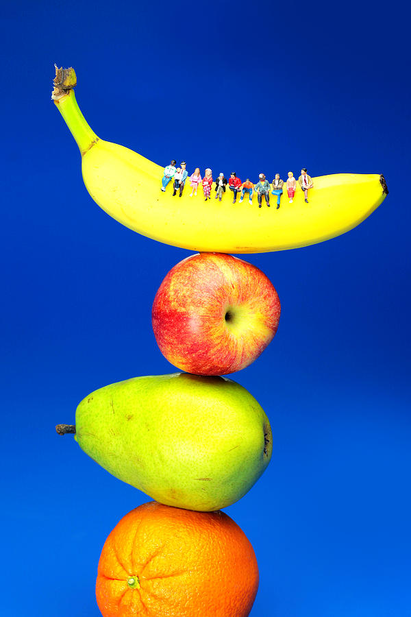 Sitting on fruits mountain little people on food Photograph by Paul Ge