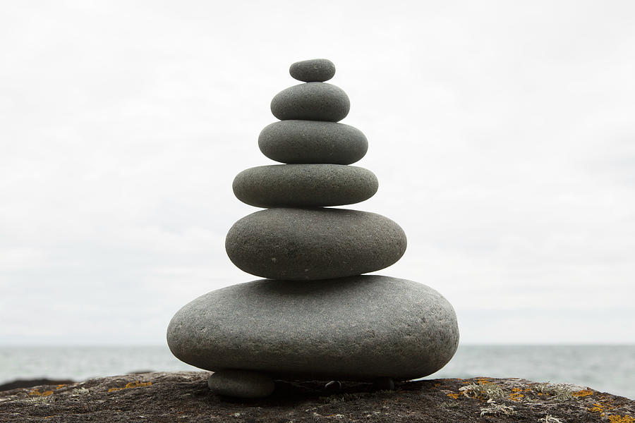 Six Coastal Stones Balanced On Top Of Photograph by Mickey Cashew