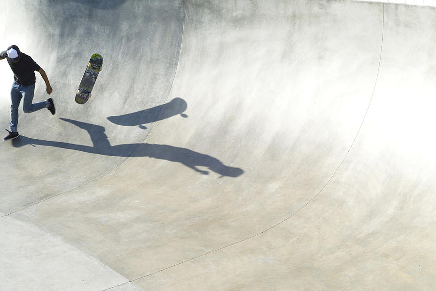 Skate boarder falling off skate baord. Photograph by Peter Starman