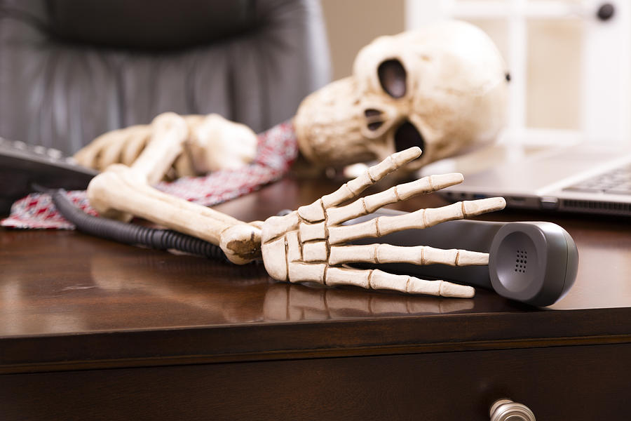 Skeleton of man who died while waiting on hold.  Telephone. Photograph by Fstop123