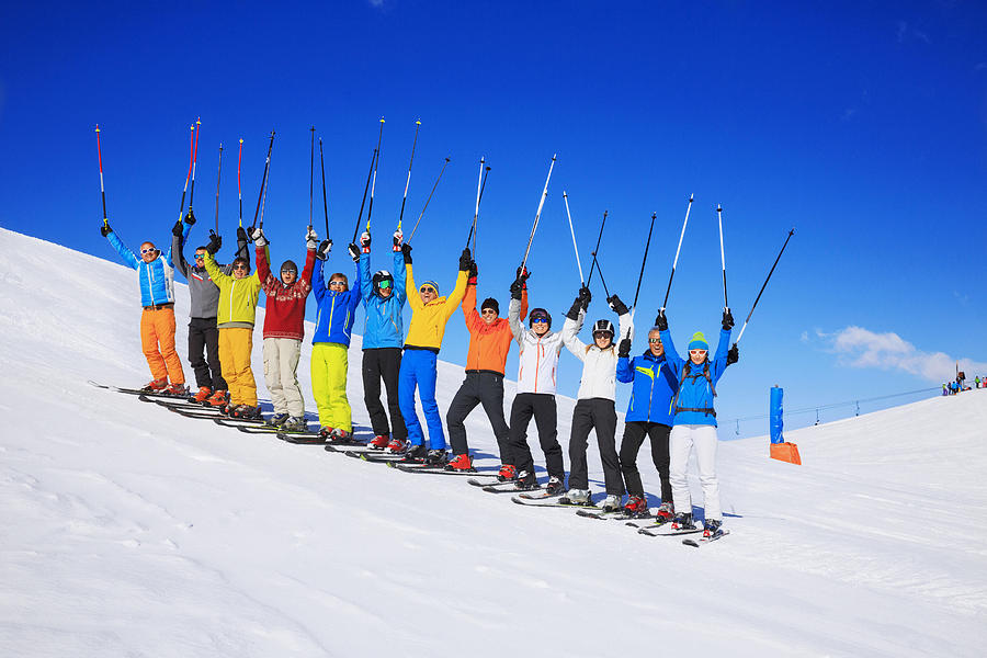 Ski club school skiing trips   Colorful group of snow skiers Photograph by Ultramarinfoto