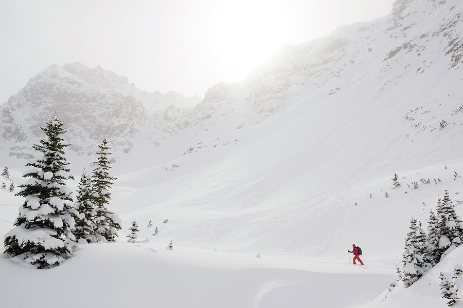 Skier Climbs Snowy Ridge Below Misty Photograph by Ascent Xmedia