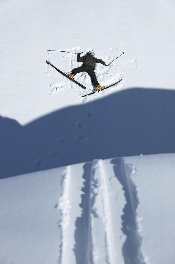 Skier head down in snow Photograph by Jakob Helbig