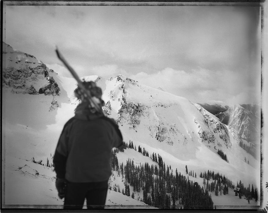 Black And White Photograph - Skier Looks Out Into The Big Mountains by Tony Demin