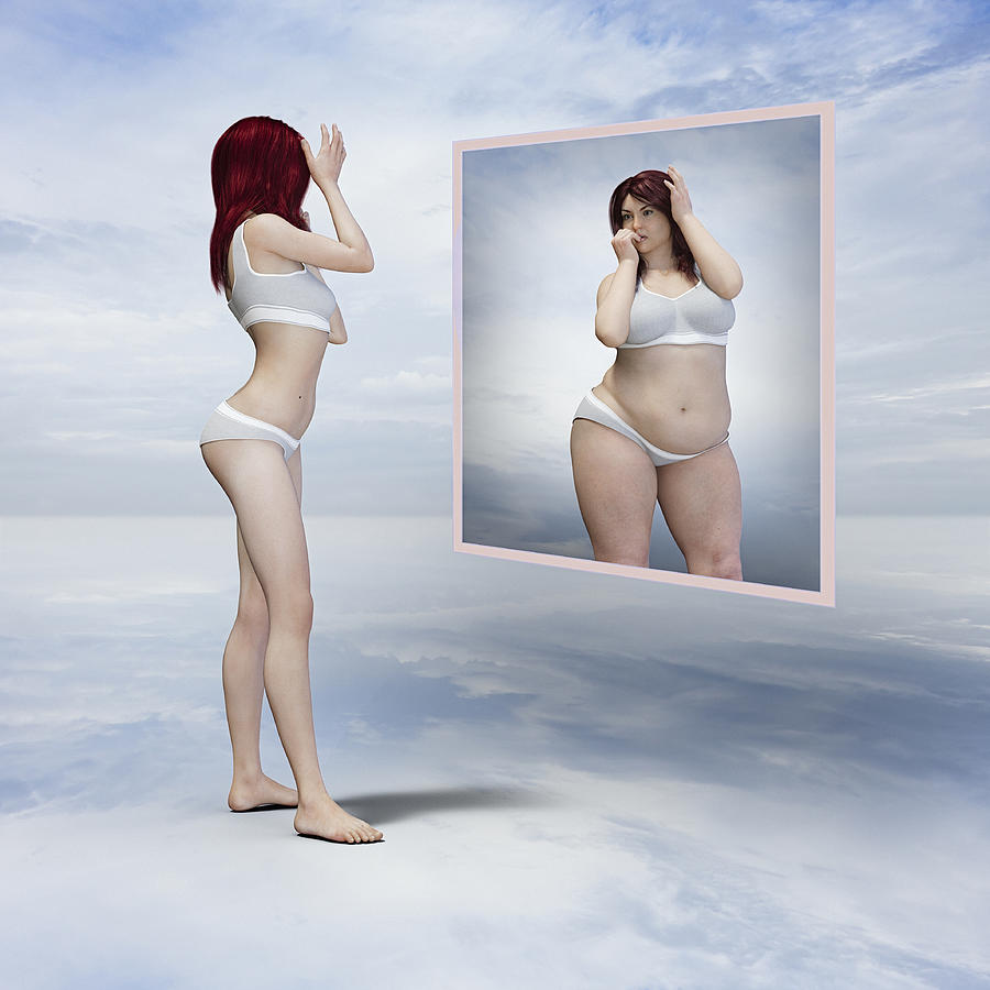 Skinny woman viewing overweight reflection in floating mirror Photograph by Donald Iain Smith