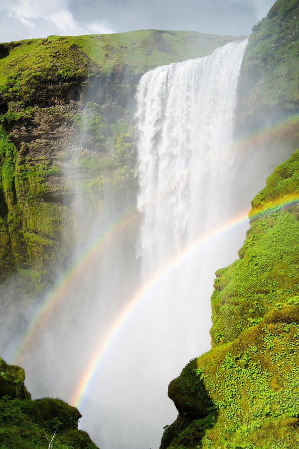 Skogafoss waterfall in Iceland with two rainbows Photograph by Matthias Hauser