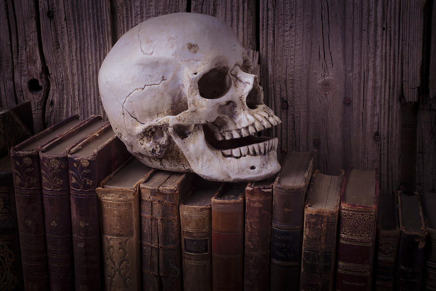 Skull Photograph - Skull on old books by Garry Gay