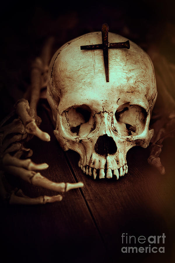 Skull with metal cross and skeleton hands Photograph by Sandra Cunningham