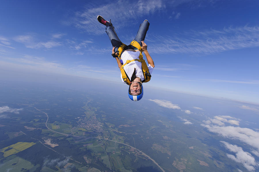 Skydiver in mid-air Photograph by Johner Images