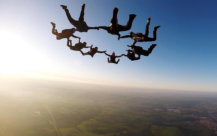 Skydiving group at the sunset Photograph by Graiki