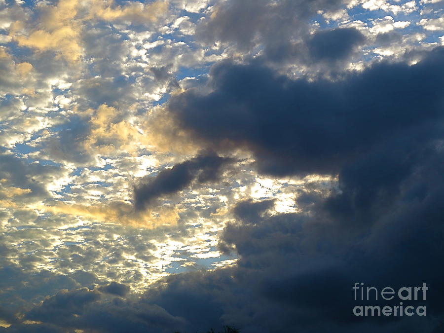 Skyfull of clouds with a trace of golden at sunset. Photograph by Robert Birkenes