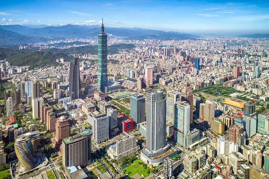 Skyscrapers of a modern city with overlooking perspective under blue sky in Taipei, Taiwan Photograph by GoranQ