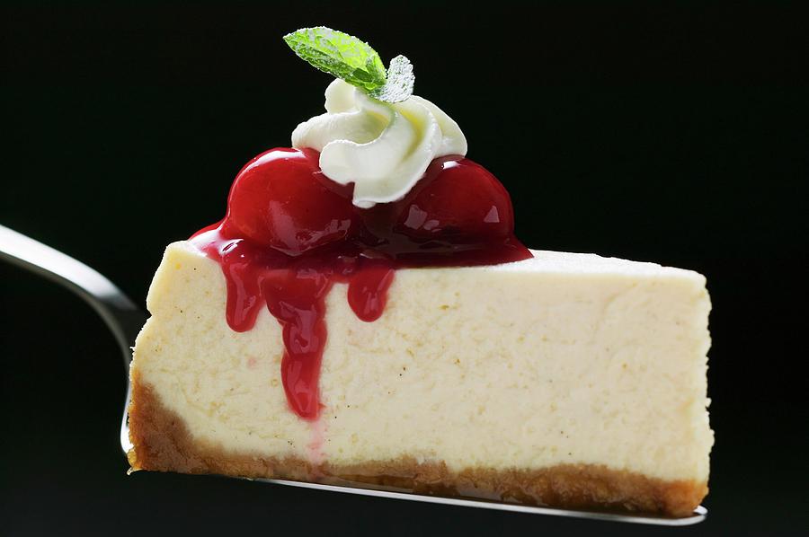 Slice Of Cheesecake With Cherries, Cream, Mint On Cake Server ...