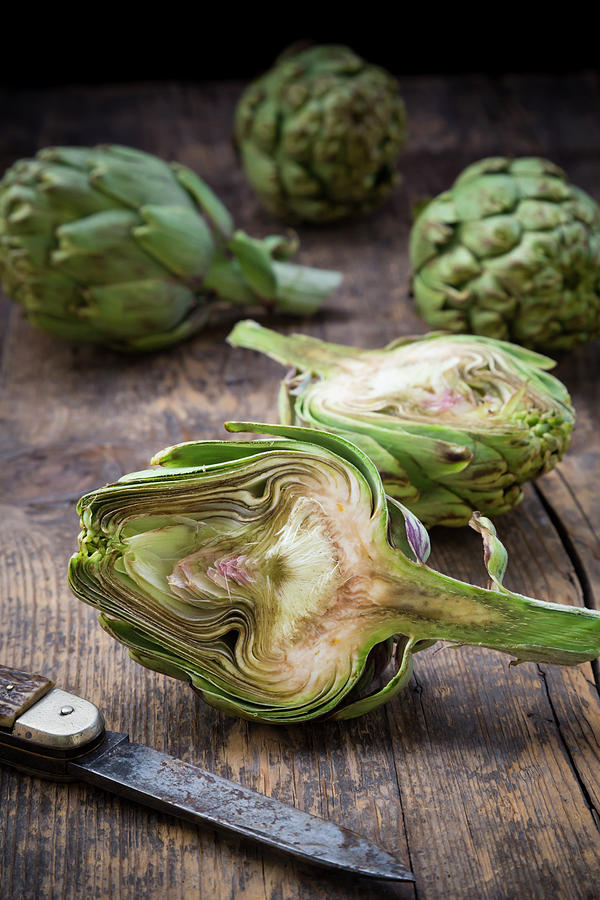 Sliced And Whole Organic Artichokes And Photograph by Westend61