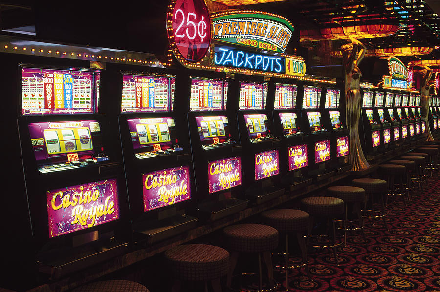 Slot machines in casino Photograph by Comstock