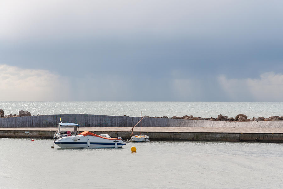 Small boat and rain at sea Photograph by Ingela Christina Rahm - Fine