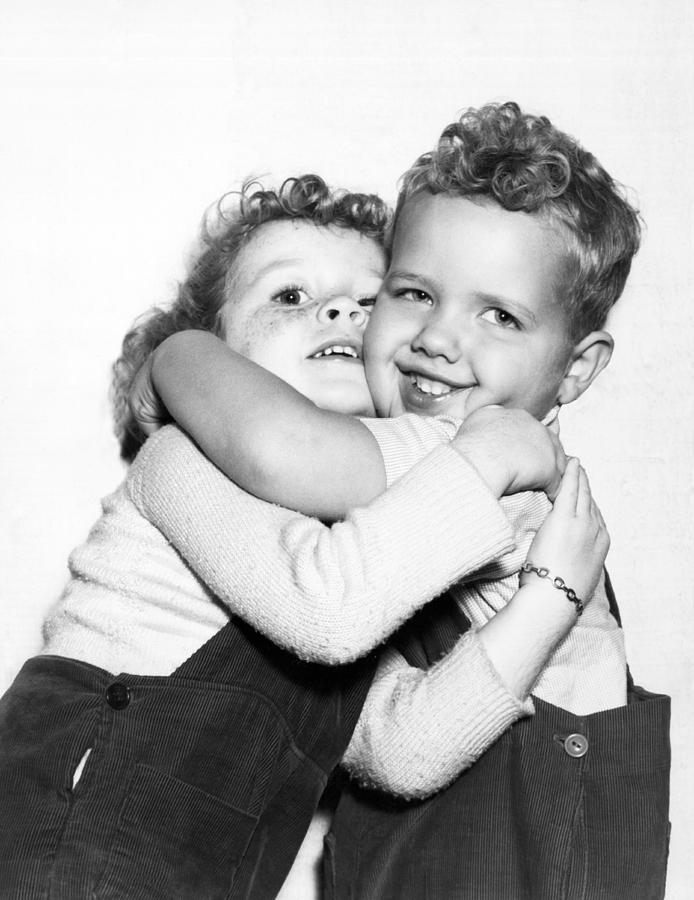 Black And White Photograph - Small Boy Hugging His Sister by Ed Estabrook