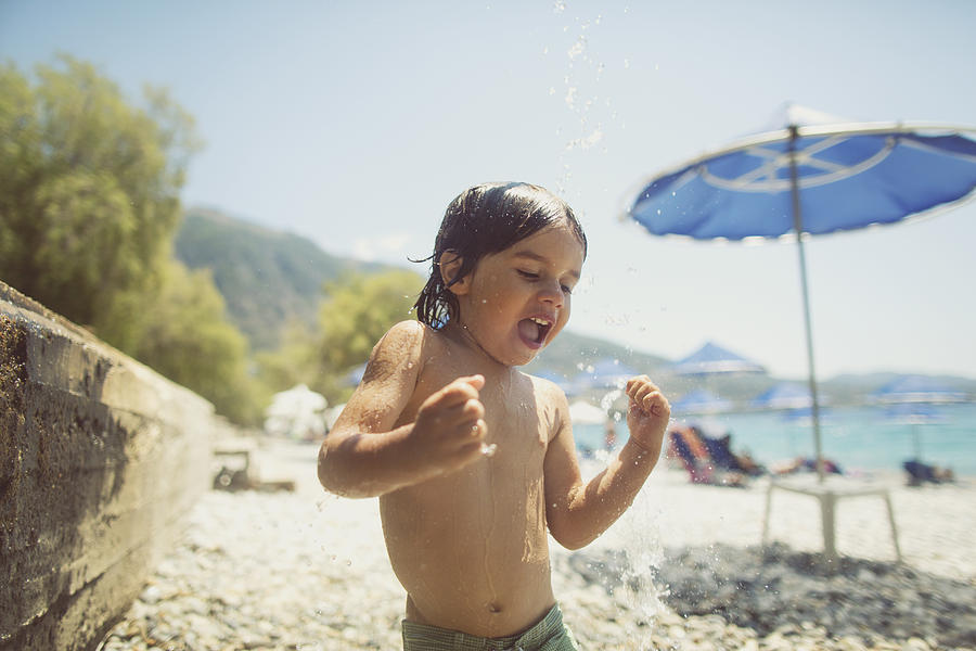 Small boy playing with the shower on the beach Photograph by Thanasis Zovoilis