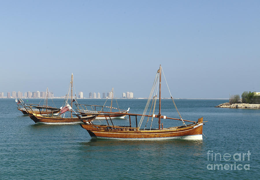 Small dhows and Pearl development Photograph by Paul Cowan