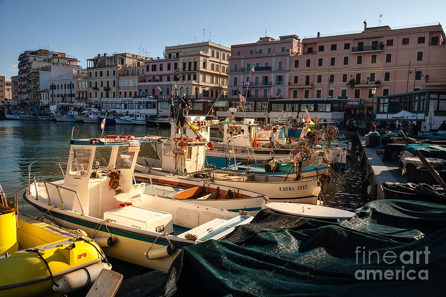 small working fishing boats moored stern first in Anzio harbour Photograph by Peter Noyce