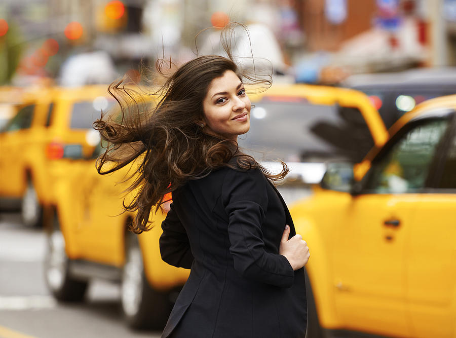 Smiling beautiful girl with dispelled hair walking on NY street Photograph by Maodesign