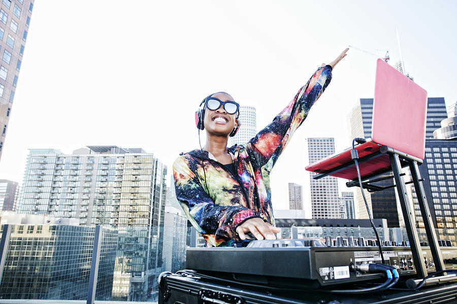 Smiling Black DJ on urban rooftop Photograph by Peathegee Inc