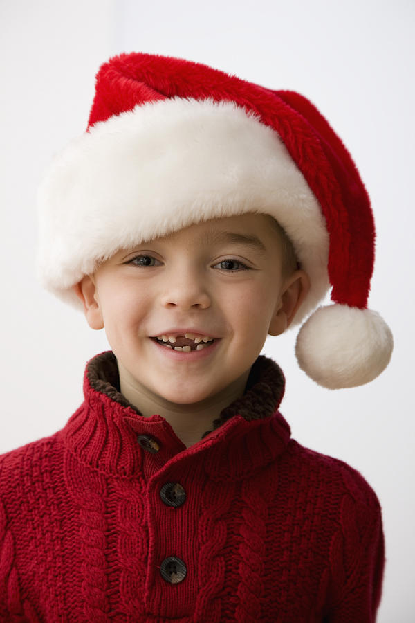Smiling Caucasian boy in santa hat Photograph by Jose Luis Pelaez Inc