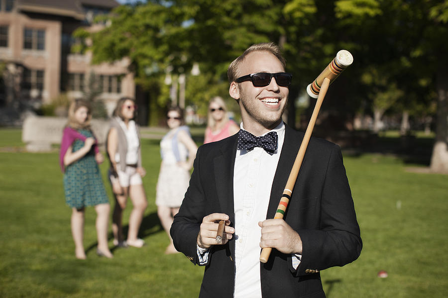 Smiling Caucasian man holding croquet mallet Photograph by Hill Street Studios