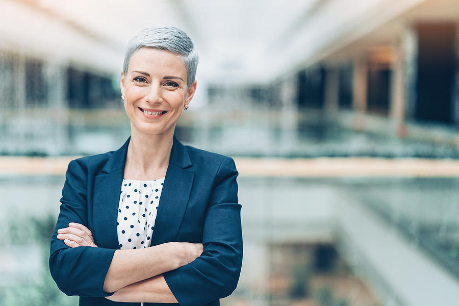 Smiling middle aged businesswoman Photograph by Pixelfit