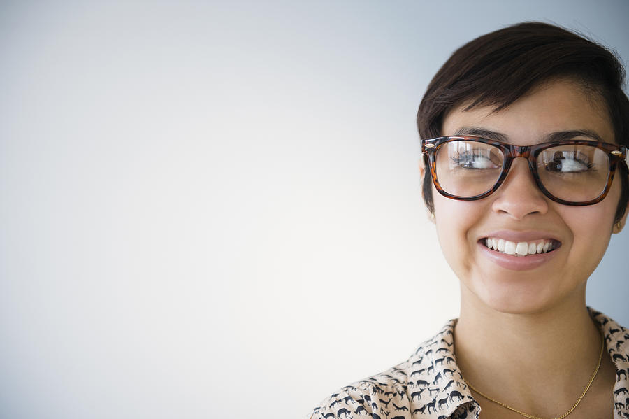 Smiling mixed race woman wearing eyeglasses Photograph by JGI/Jamie Grill