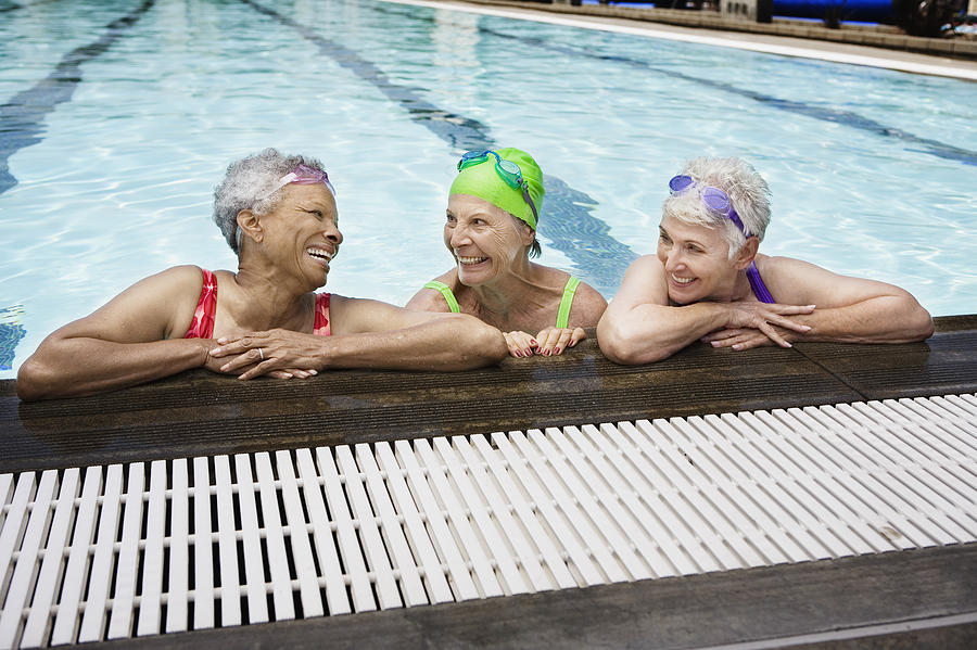 Smiling senior women in pool Photograph by Jupiterimages