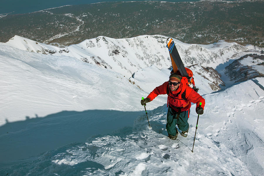 Smiling Skier Hiking Up Snowy Mountain Photograph by Adam Clark - Fine ...