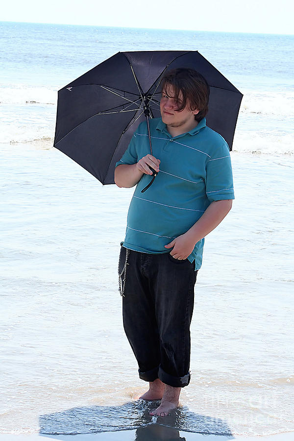 Smiling Teen With Umbrella In Surf Photograph by Susan Stevenson