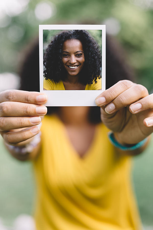 Smiling woman showing selfie Photograph by Martin-dm