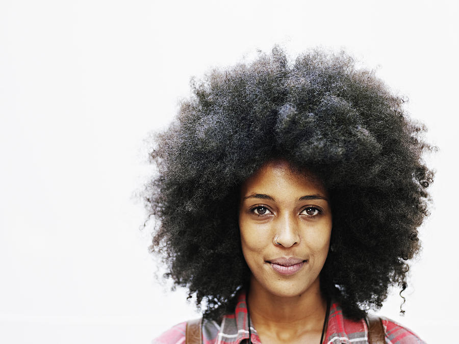Smiling woman with afro hairstyle Photograph by Thomas Barwick
