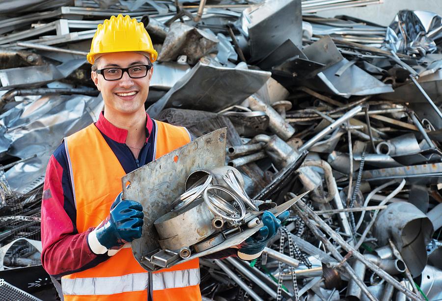 Smiling Worker in Metal Landfill Photograph by SeanShot