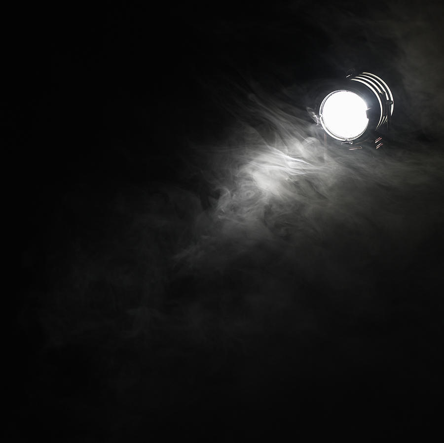 Smoke beneath spotlight Photograph by Ryan McVay