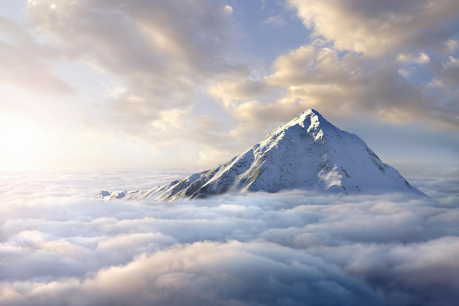 Snow-covered mountaintop above clouds Photograph by Chris Clor