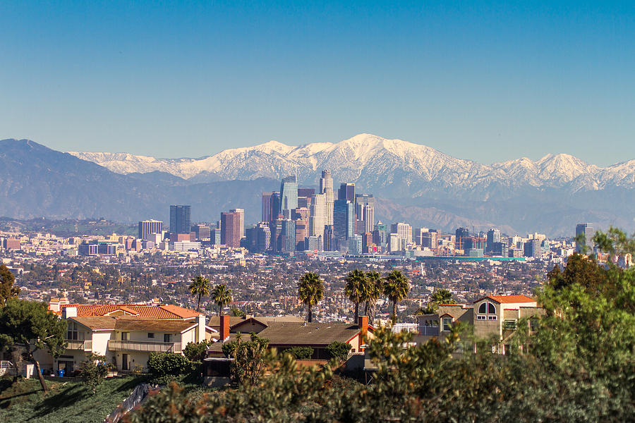 Snowed peaks mountains and downtown Los Angeles cityscape Photograph by Jorge Villalba