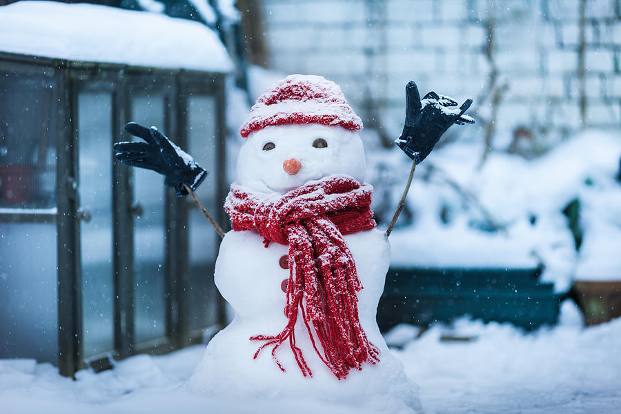 Snowman built on city street Photograph by Dan Brownsword