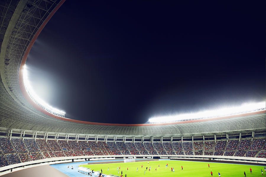 Soccer game in a stadium at night Photograph by FangXiaNuo