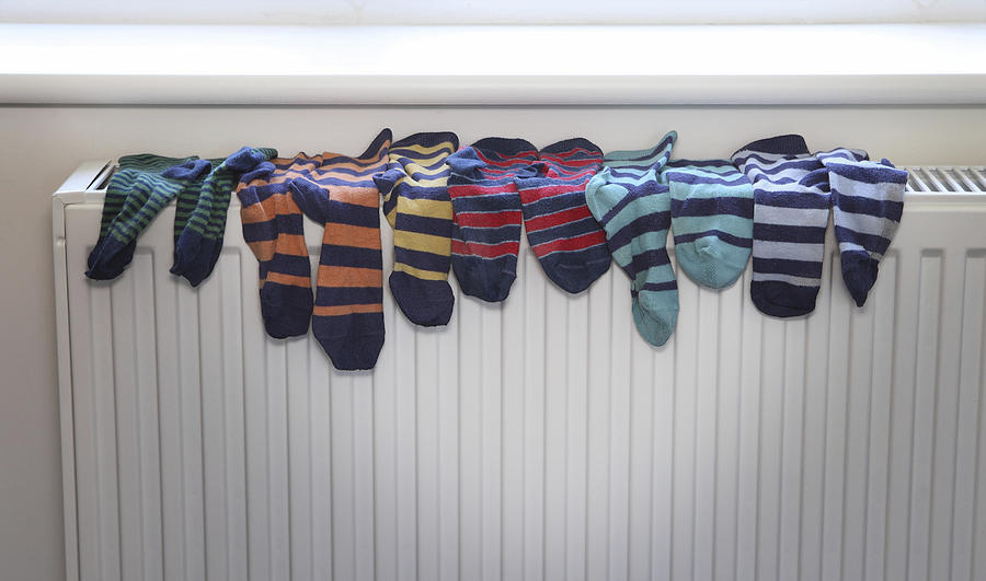 Socks drying on radiator Photograph by Image Source