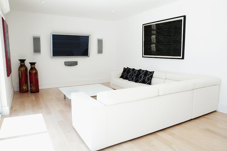 Sofas, television and wall art in modern living room Photograph by Camilo Morales