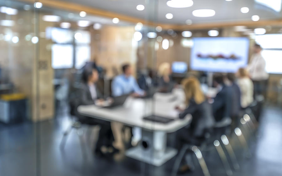 Soft focus business people sitting in conference room Photograph by Simonkr