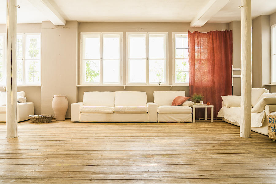 Spacious living room with wooden floor Photograph by Westend61