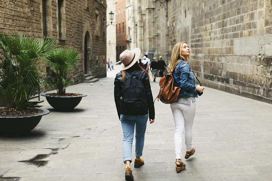 Spain, Barcelona, two young women walking in the city Photograph by Westend61