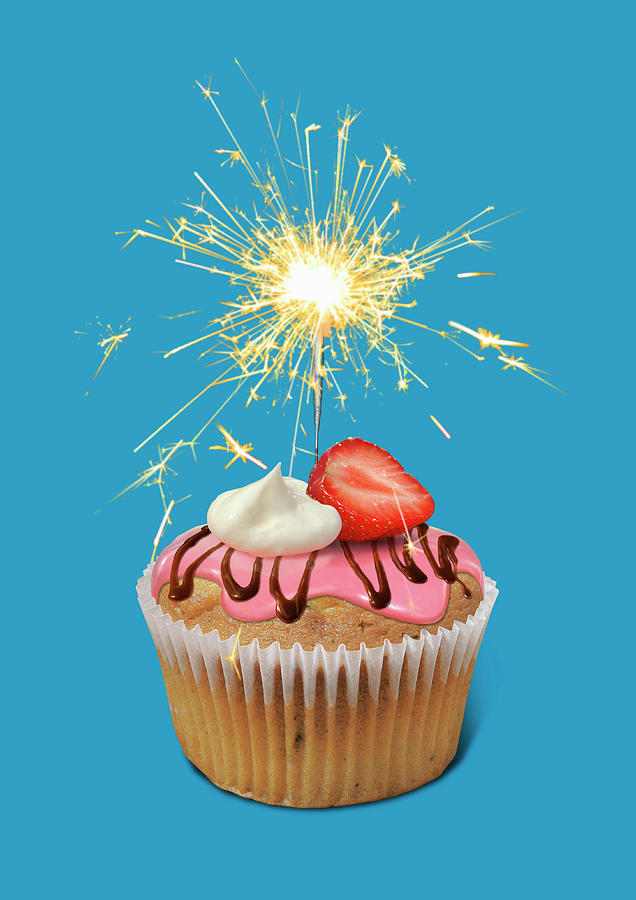 Sparkler Burning On Top Of Cupcake Photograph by Ikon Ikon Images