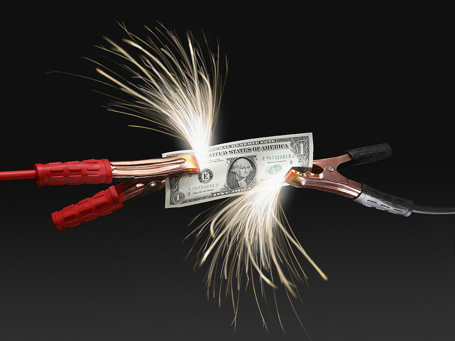 Sparks coming off US dollar bill attached to jumper cables Photograph by Steven Puetzer