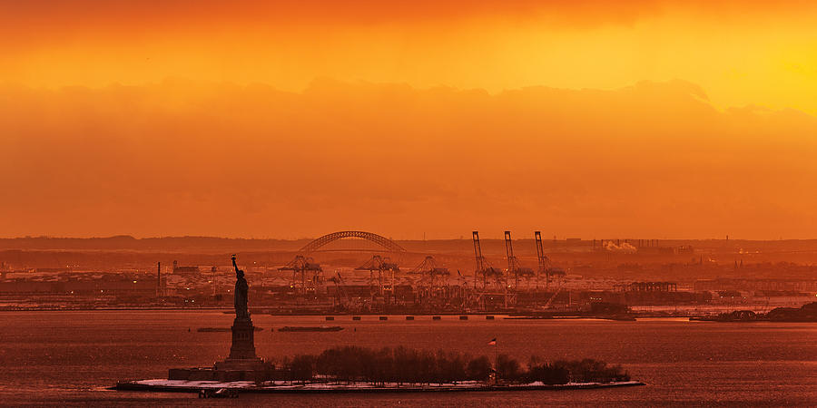 Spectacular Orange Sunset on Liberty Island and Statue of Liberty Photograph by David Giral